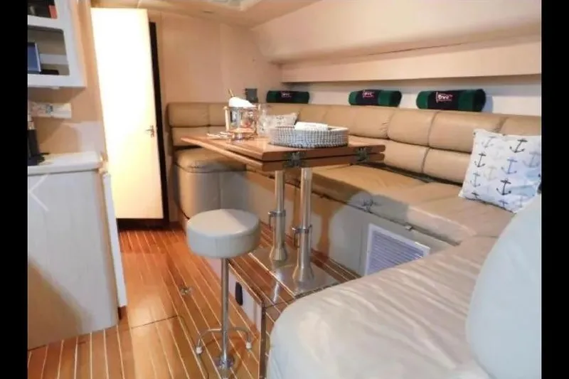 Slide: The Image of Interior of 1995 Tiara Yachts 4000 Express with cozy seating and elegant decor. - 34