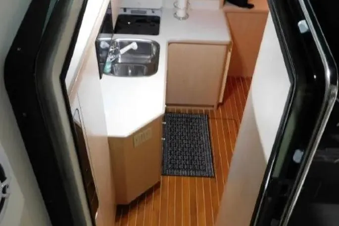 Slide: The Image of 1995 Tiara Yachts 4000 Express interior kitchen with sink and wooden flooring. - 36