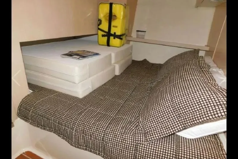 Slide: The Image of 1995 Tiara Yachts 4000 Express cabin interior with bed, cushions, and life jacket. - 37