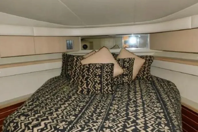 Slide: The Image of Cozy cabin interior of 1995 Tiara Yachts 4000 Express with patterned bedding. - 38