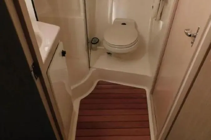 Slide: The Image of Bathroom interior of 1995 Tiara Yachts 4000 Express with wooden floor accents. - 39