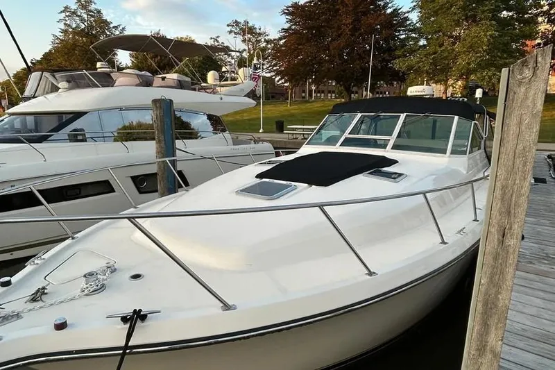 Slide: The Image of 1995 Tiara Yachts 4000 Express docked, showcasing sleek design and spacious deck. - 4