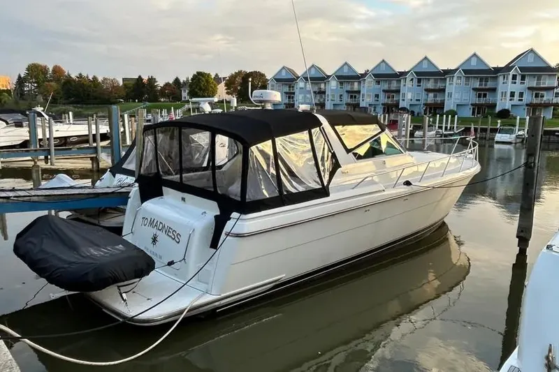 Slide: The Image of 1995 Tiara Yachts 4000 Express docked at marina with waterfront homes in background. - 5