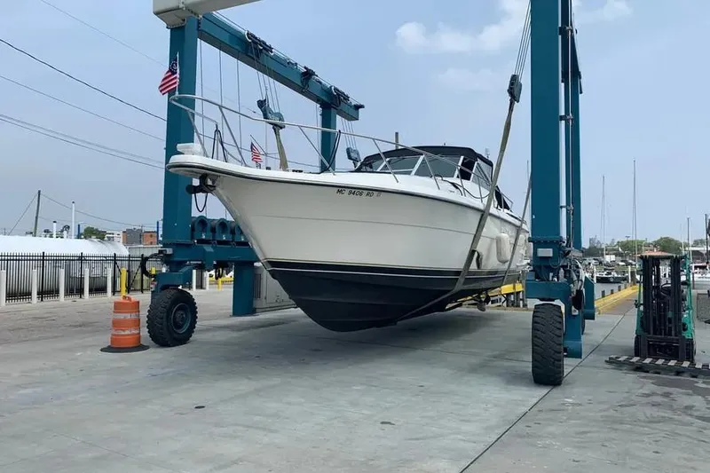 Slide: The Image of 1995 Tiara Yachts 4000 Express on a boat lift at a marina. - 6