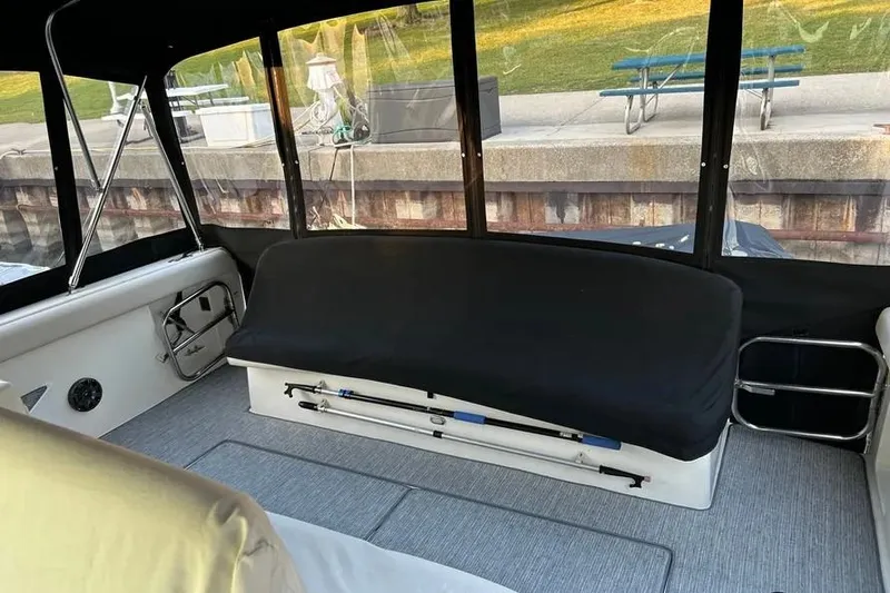 Slide: The Image of Interior of a 1995 Tiara Yachts 4000 Express with covered seating and clear windows. - 9