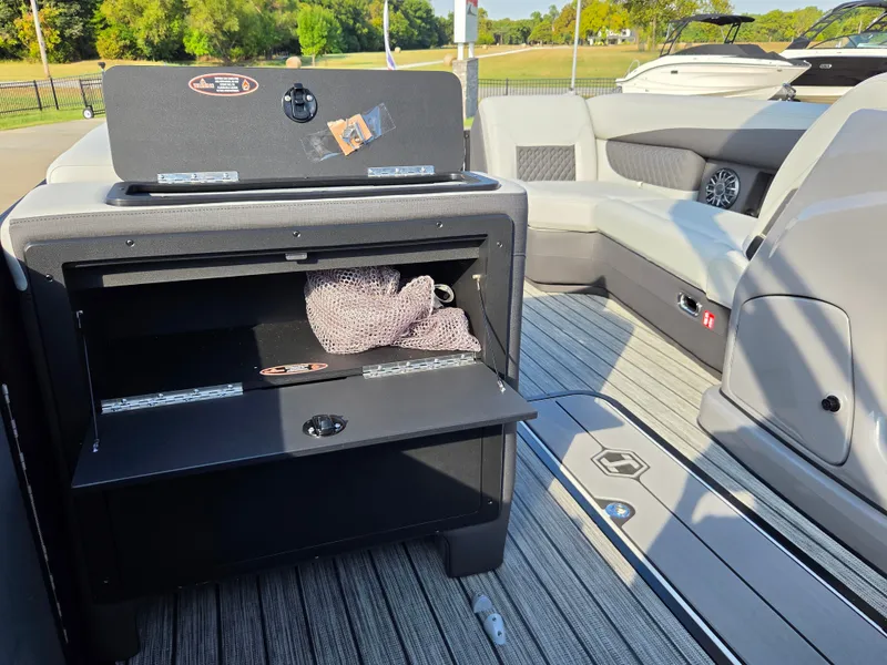 Slide: The Image of The image shows the interior of a 2027 Harris 250SL with gray seating and storage space. - 14