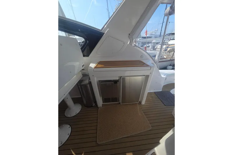 Slide: The Image of 2001 Tiara Yachts 5200 Express interior with sleek cabinetry and teak flooring. - 11