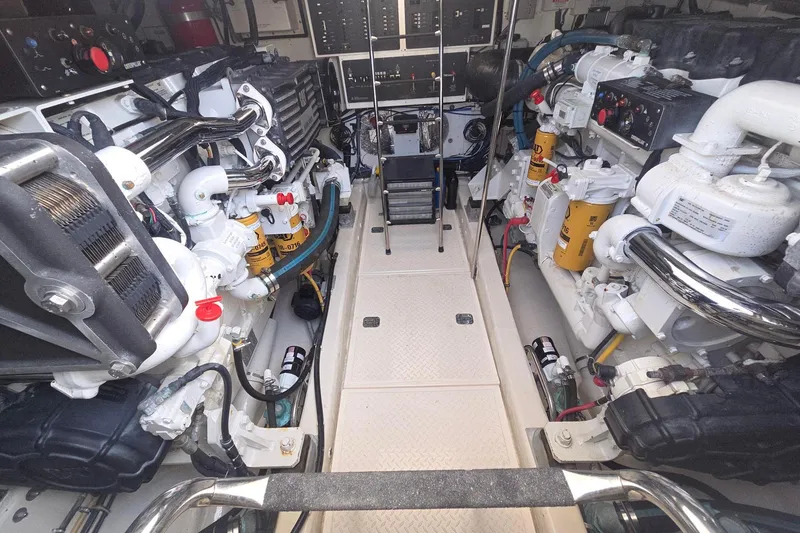 Slide: The Image of Engine room of a 2001 Tiara Yachts 5200 Express, showcasing dual engines and mechanical components. - 16