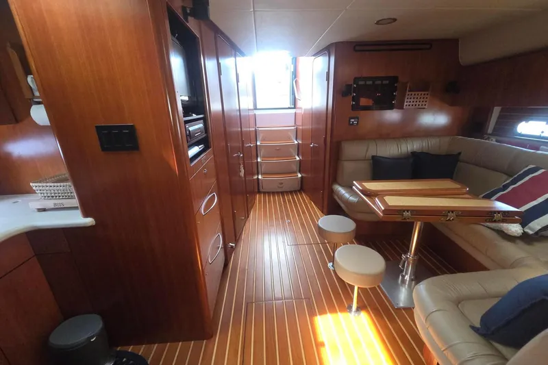 Slide: The Image of Luxurious interior of 2001 Tiara Yachts 5200 Express with wood finishes and comfortable seating. - 18