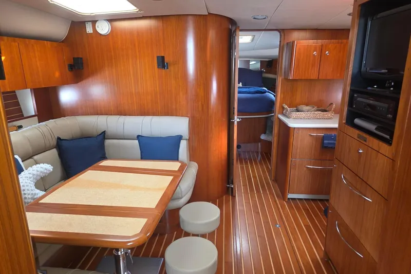 Slide: The Image of Luxurious interior of a 2001 Tiara Yachts 5200 Express with wood finishes and cozy seating. - 21