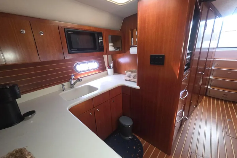 Slide: The Image of Luxurious 2001 Tiara Yachts 5200 Express kitchen with wood cabinetry and modern appliances. - 23