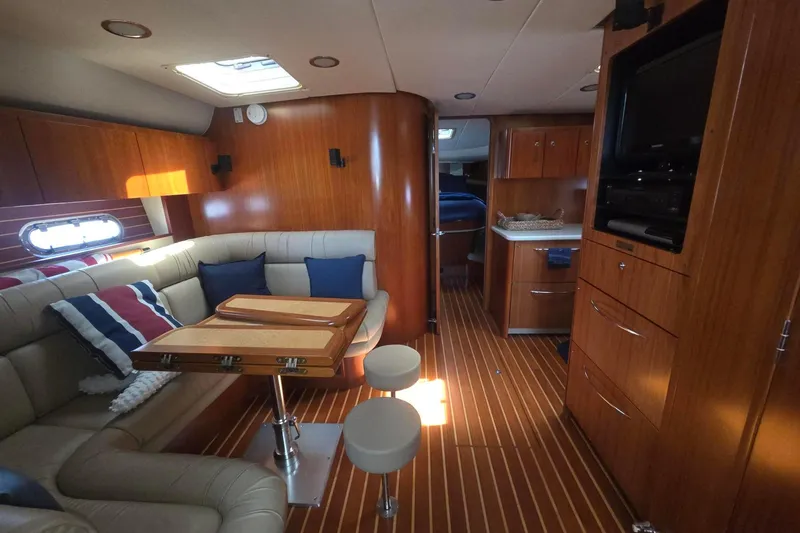 Slide: The Image of Luxurious interior of 2001 Tiara Yachts 5200 Express with wood finishes and cozy seating. - 25