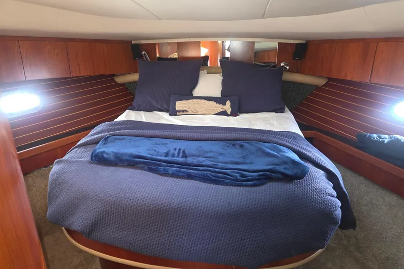 Slide: The Image of Luxurious cabin interior of 2001 Tiara Yachts 5200 Express with cozy bedding. - 27