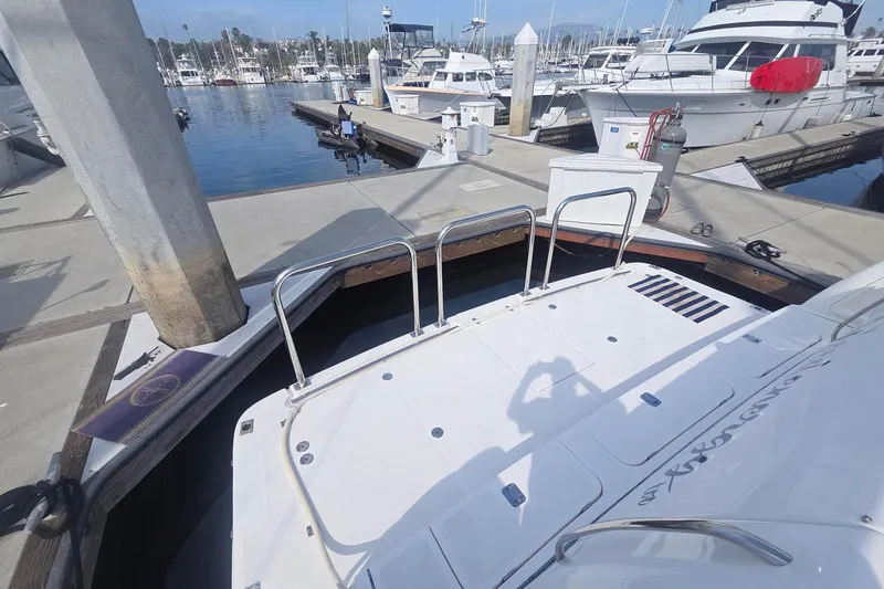 Slide: The Image of 2001 Tiara Yachts 5200 Express docked at marina with other boats. - 6