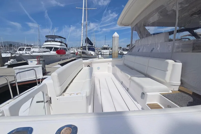 Slide: The Image of Spacious deck of a 2001 Tiara Yachts 5200 Express at a marina. - 7