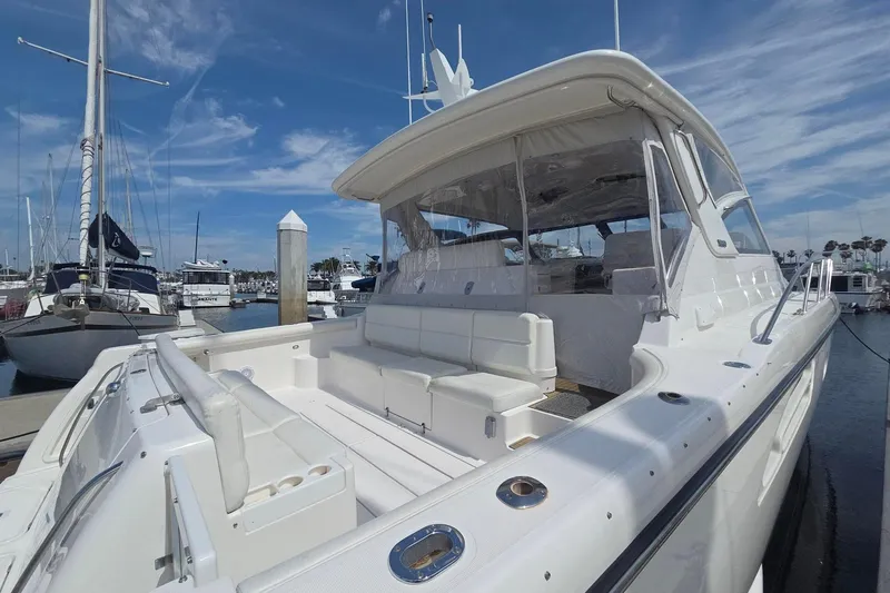 Slide: The Image of 2001 Tiara Yachts 5200 Express docked at marina under clear blue sky. - 8