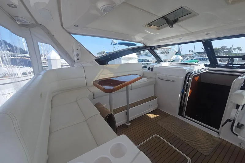 Slide: The Image of Luxurious interior of 2001 Tiara Yachts 5200 Express with white seating and wooden accents. - 9