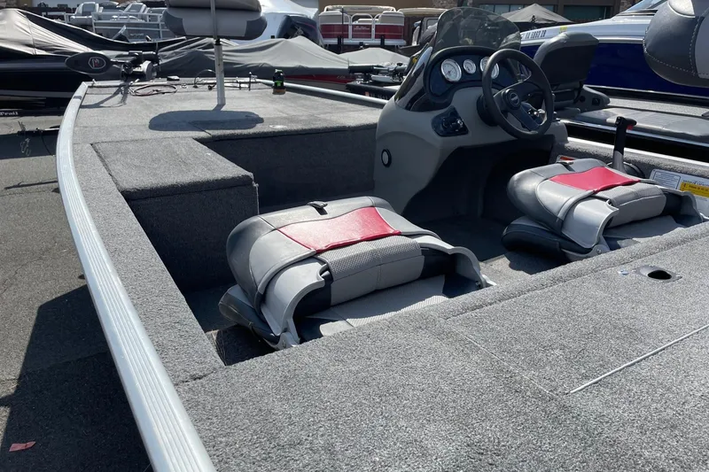 Slide: The Image of 2014 Tracker Pro 170 boat interior with seating and steering console. - 4