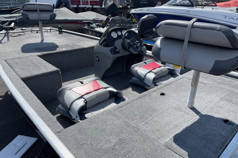 Slide: The Image of 2014 Tracker Pro 170 boat interior with gray and red seating, steering console. - 6