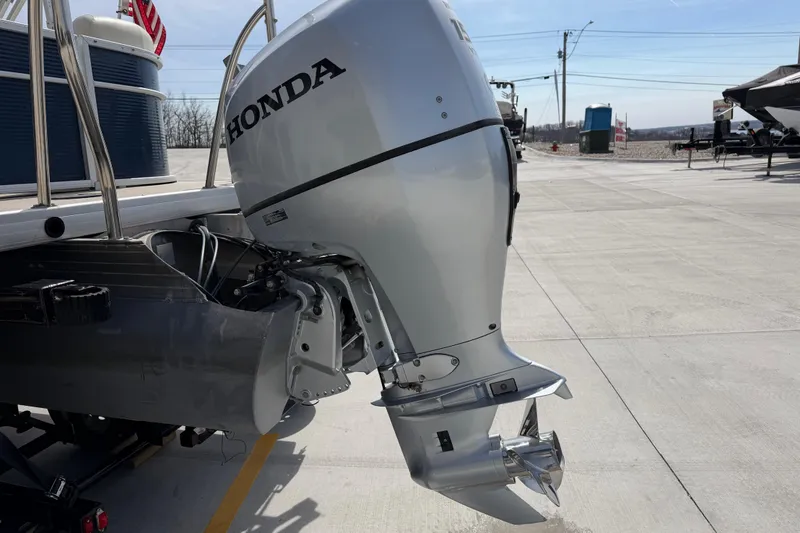 Slide: The Image of 2018 Godfrey Sweetwater 2486 SB with Honda outboard motor on a sunny day. - 13