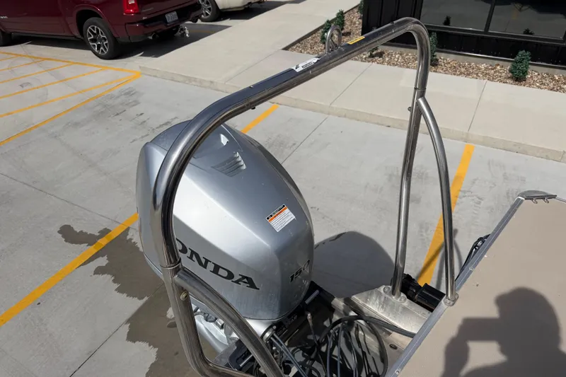 Slide: The Image of 2018 Godfrey Sweetwater 2486 SB with Honda outboard motor in parking lot. - 15