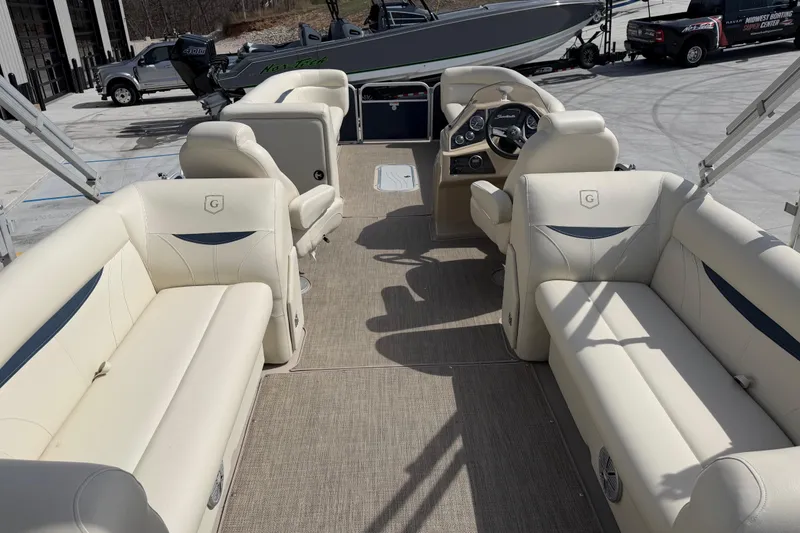 Slide: The Image of 2018 Godfrey Sweetwater 2486 SB pontoon boat interior with beige seating and helm. - 16