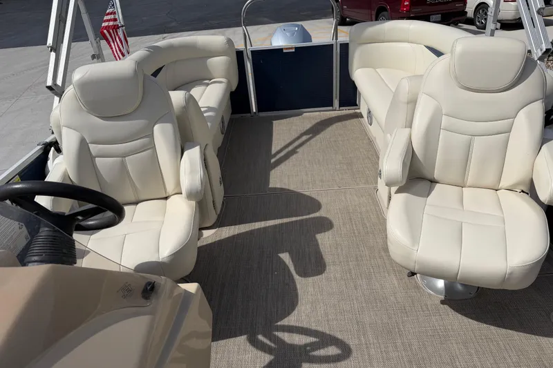 Slide: The Image of 2018 Godfrey Sweetwater 2486 SB pontoon boat interior with plush seating and steering wheel. - 17