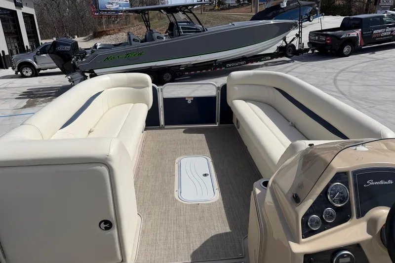 Slide: The Image of 2018 Godfrey Sweetwater 2486 SB pontoon boat interior with beige seating and dashboard. - 20