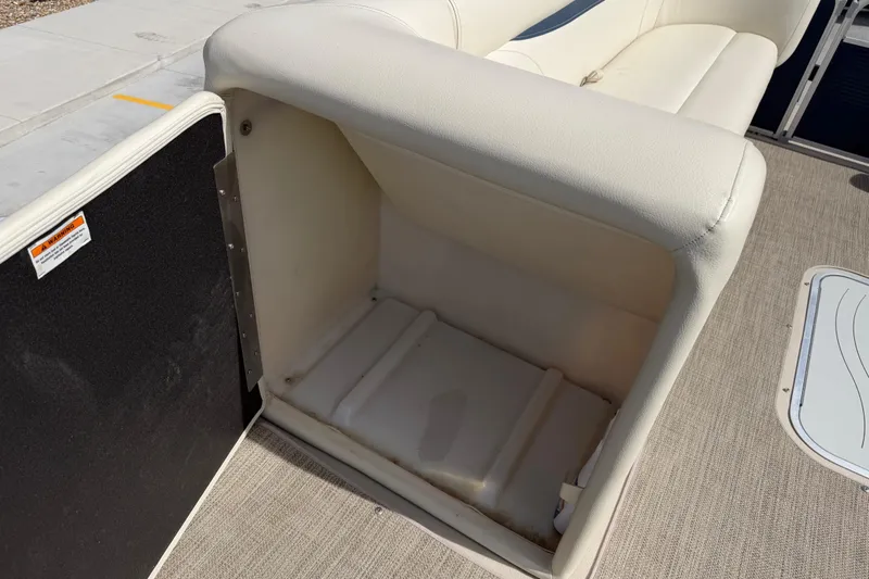 Slide: The Image of Open storage compartment on 2018 Godfrey Sweetwater 2486 SB boat with beige upholstery. - 21