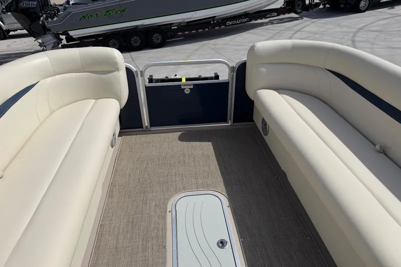 Slide: The Image of 2018 Godfrey Sweetwater 2486 SB pontoon boat interior with beige seating and carpeted floor. - 23