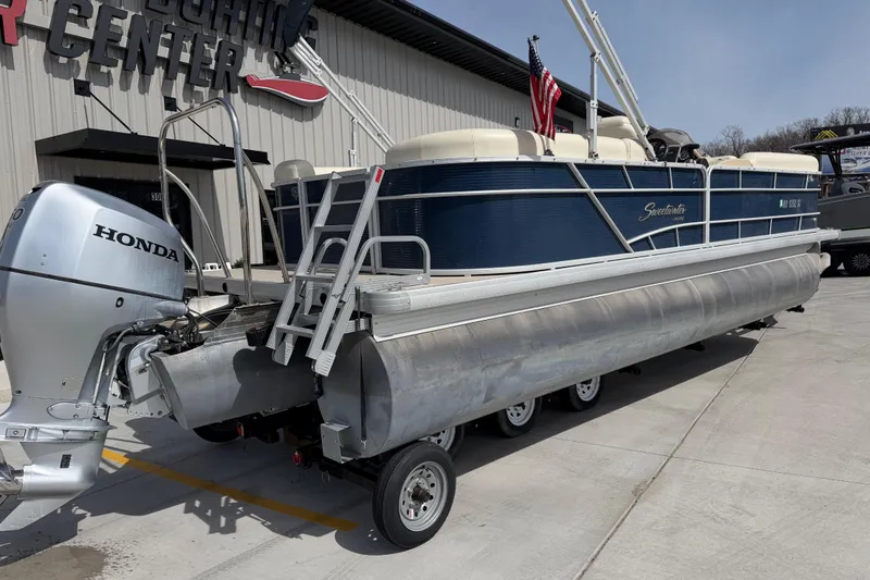 Slide: The Image of 2018 Godfrey Sweetwater 2486 SB pontoon boat with Honda outboard motor on trailer. - 3