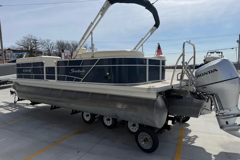 Slide: The Image of 2018 Godfrey Sweetwater 2486 SB pontoon boat with Honda outboard motor on trailer. - 6