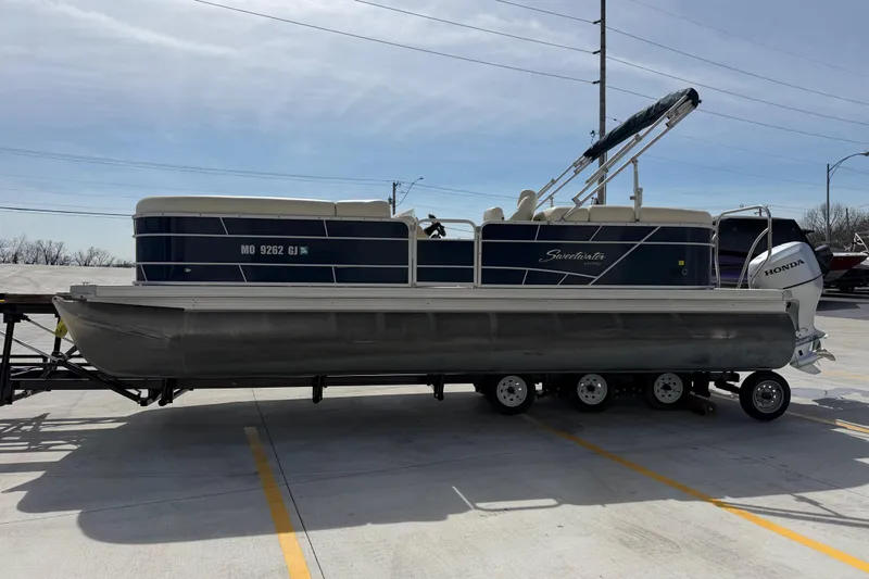 Slide: The Image of 2018 Godfrey Sweetwater 2486 SB pontoon boat on trailer in parking lot. - 7