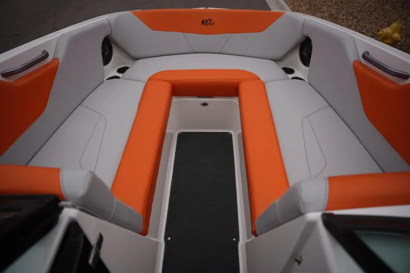 Slide: The Image of 2021 MasterCraft NXT24 boat interior with orange and gray seating. - 11