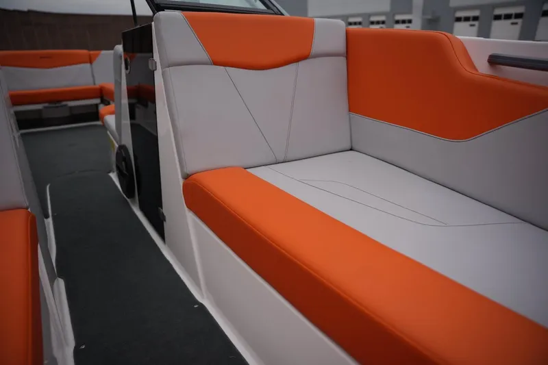 Slide: The Image of 2021 MasterCraft NXT24 boat interior with orange and gray seating. - 12