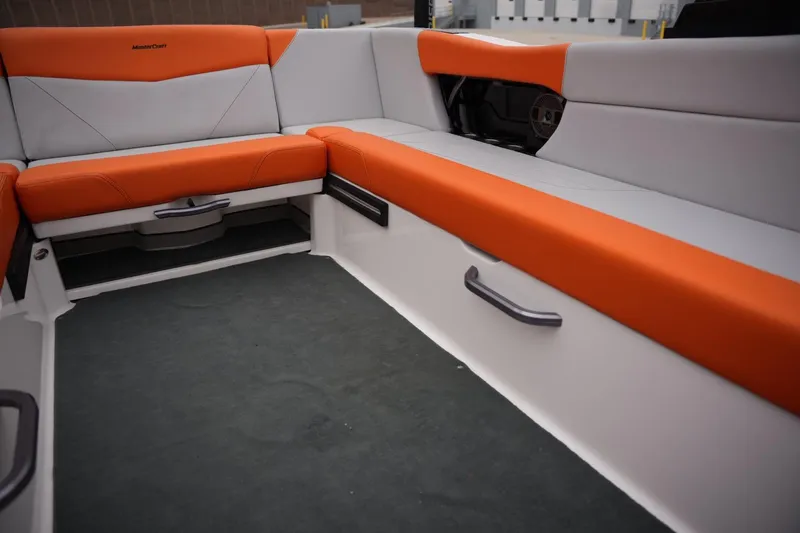 Slide: The Image of 2021 MasterCraft NXT24 boat interior with orange and gray seating. - 13