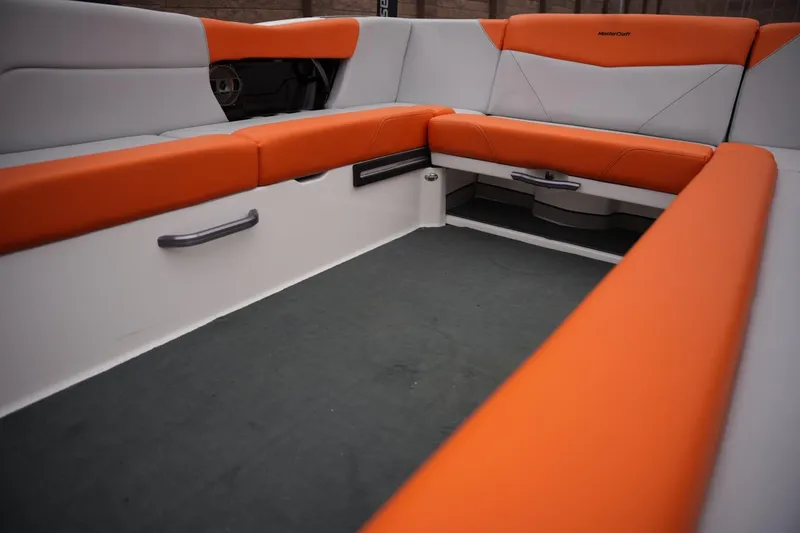 Slide: The Image of 2021 MasterCraft NXT24 boat interior with orange and gray seating. - 14
