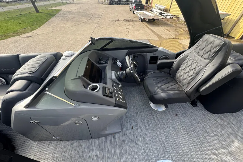 Slide: The Image of 2023 Bennington 30 QXFBAX2 boat interior with luxurious seating and modern dashboard. - 18