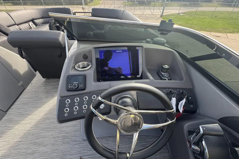 Slide: The Image of 2023 Bennington 30 QXFBAX2 boat dashboard with steering wheel and control panel. - 20
