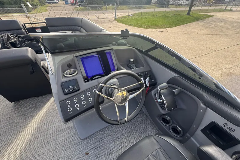Slide: The Image of 2023 Bennington 30 QXFBAX2 boat dashboard with steering wheel and control panel. - 21