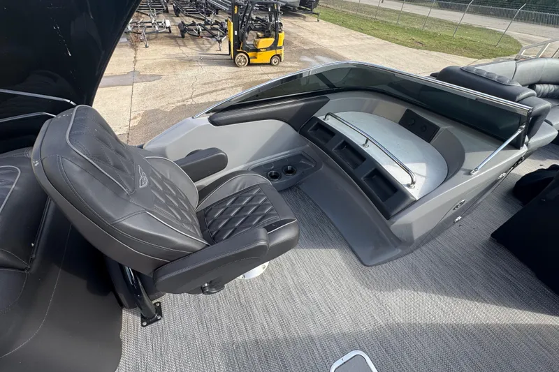 Slide: The Image of 2023 Bennington 30 QXFBAX2 boat interior with luxurious seating and modern dashboard. - 24