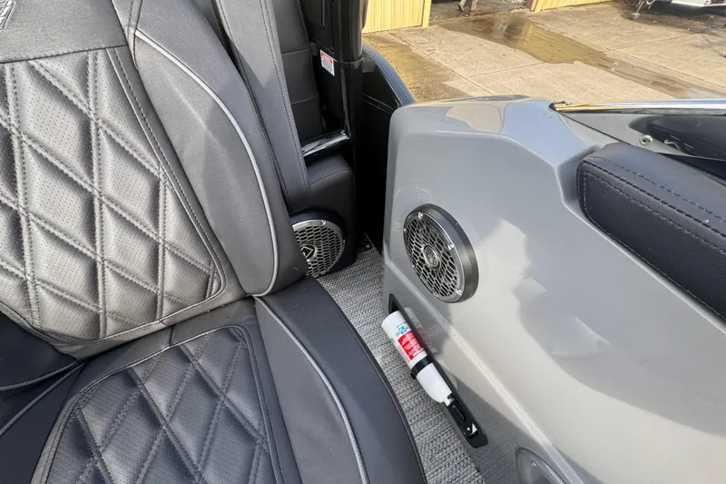 Slide: The Image of 2023 Bennington 30 QXFBAX2 interior with black quilted seats and speaker detail. - 25