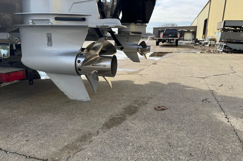 Slide: The Image of 2023 Bennington 30 QXFBAX2 boat propellers on concrete surface, showcasing Mercury 23P propellers. - 31