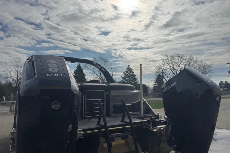 Slide: The Image of 2023 Bennington 30 QXFBAX2 boat with dual Mercury 400 V10 engines under a cloudy sky. - 37