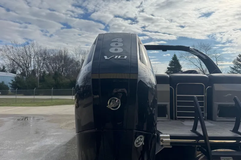 Slide: The Image of 2023 Bennington 30 QXFBAX2 boat with powerful 400 V10 engine, under a cloudy sky. - 38