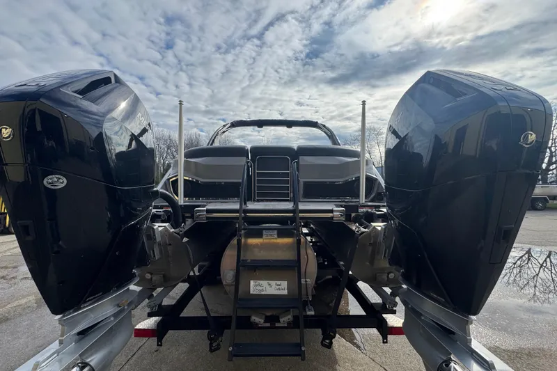 Slide: The Image of 2023 Bennington 30 QXFBAX2 boat with dual outboard motors, viewed from the rear. - 4