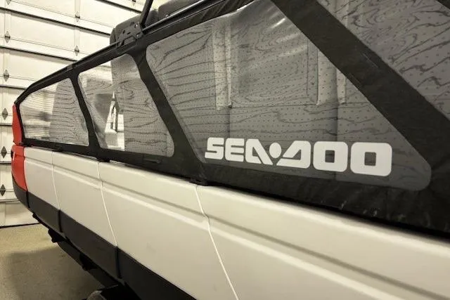 Slide: The Image of 2022 Sea-Doo Switch Cruise 21 boat side view in a garage setting. - 14