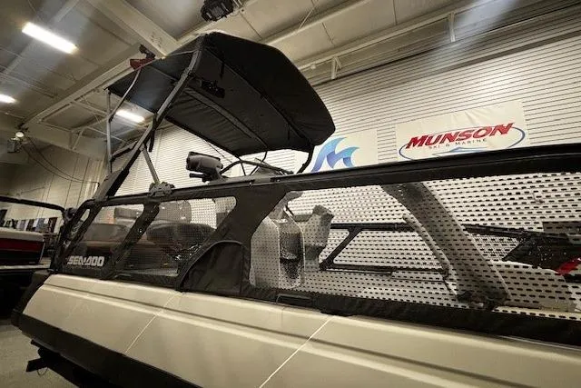Slide: The Image of 2022 Sea-Doo Switch Cruise 21 pontoon boat displayed indoors at Munson Marine. - 22