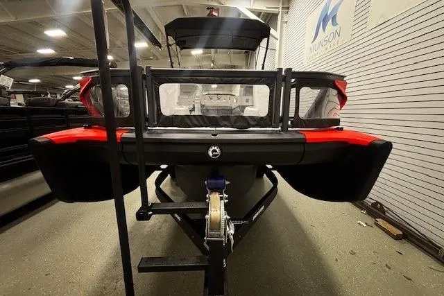 Slide: The Image of 2022 Sea-Doo Switch Cruise 21 pontoon boat in showroom, rear view. - 24