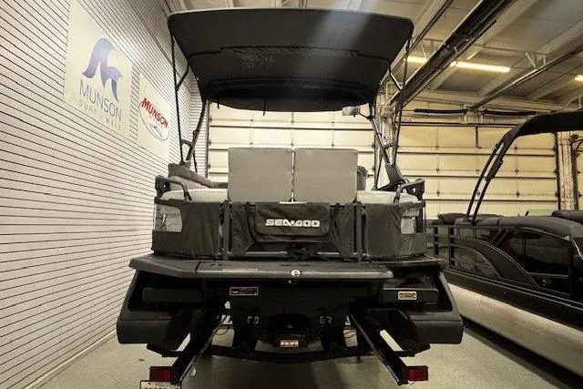 Slide: The Image of 2022 Sea-Doo Switch Cruise 21 pontoon boat in showroom, rear view. - 25